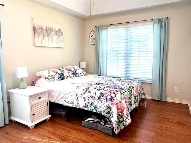 428 W Sycamore St, Nevada, MO 64772 - bedroom with wood finished floors and baseboards