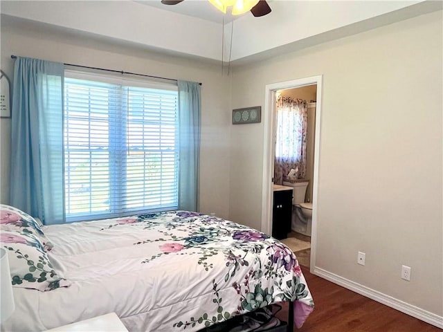 428 W Sycamore St, Nevada, MO 64772 - bedroom with wood finished floors, baseboards, connected bathroom, and ceiling fan
