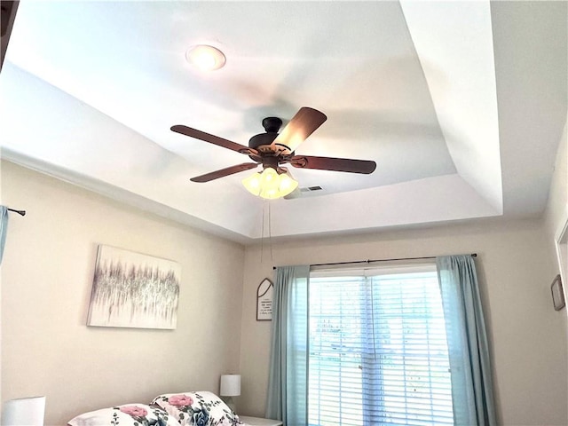 428 W Sycamore St, Nevada, MO 64772 - bedroom view of ceiling fan and a tray ceiling