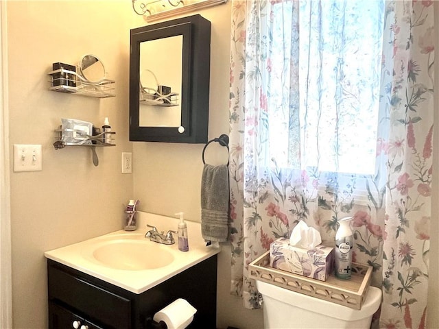 428 W Sycamore St, Nevada, MO 64772 - bathroom with vanity and toilet