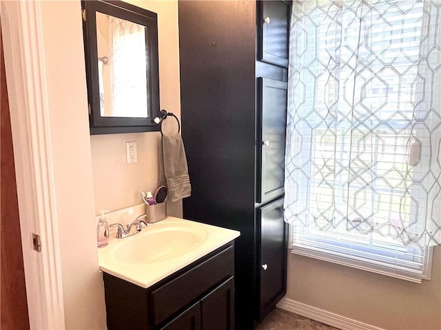 428 W Sycamore St, Nevada, MO 64772 - bathroom featuring vanity, plenty of natural light, and baseboards