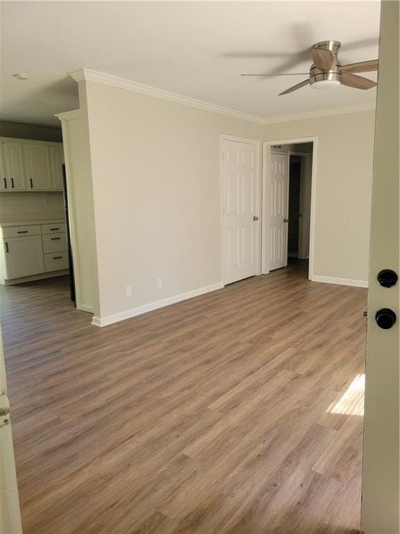 4818 E 45th St, Kansas City, MO 64130 - empty room featuring light wood-style flooring, baseboards, and ornamental molding