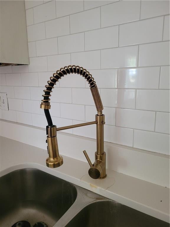 4818 E 45th St, Kansas City, MO 64130 - interior details with light countertops, a sink, and backsplash