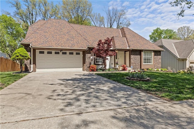 ranch-style home with concrete driveway, an attached garage, fence, brick siding, and a front lawn