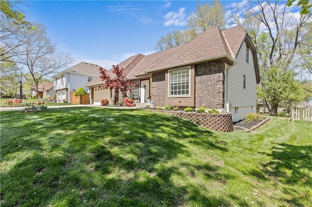 view of front of property with fence, a front lawn, an attached garage, and brick siding