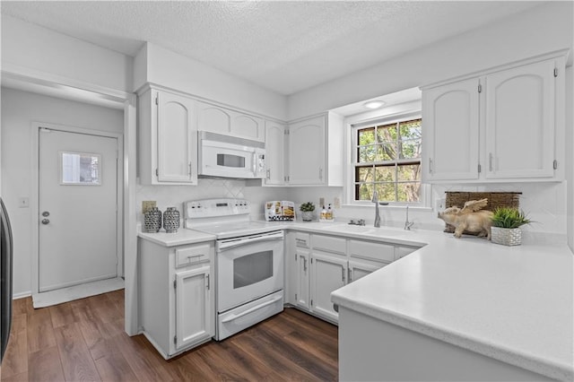 kitchen featuring a sink, dark wood-style flooring, white appliances, light countertops, and white cabinets