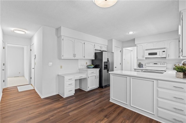 kitchen with stainless steel refrigerator with ice dispenser, electric range oven, white microwave, and a textured ceiling