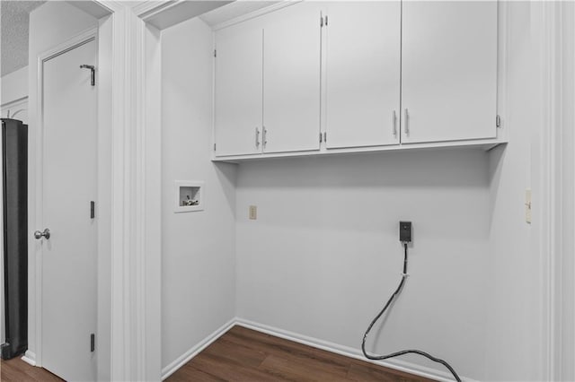 laundry area featuring washer hookup, cabinet space, dark wood-style floors, and baseboards