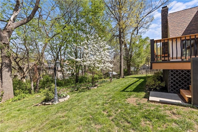 view of yard featuring fence and a wooden deck