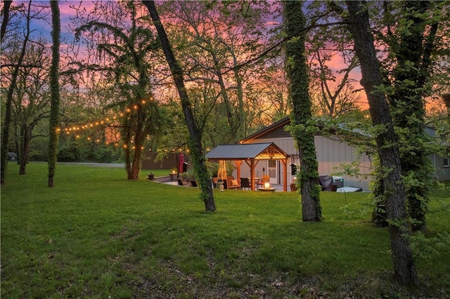 11155 Hubbard Rd, Kansas City, KS 66109 - yard at dusk with a lawn