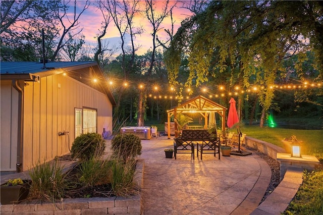 11155 Hubbard Rd, Kansas City, KS 66109 - patio terrace at dusk with a patio, a gazebo, and a covered hot tub