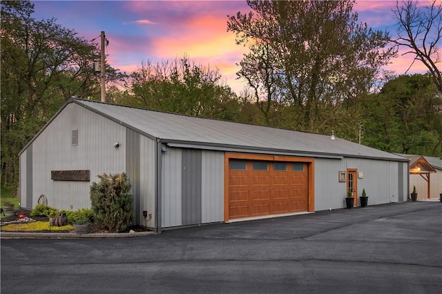 11155 Hubbard Rd, Kansas City, KS 66109 - garage at dusk with a garage