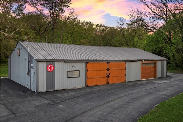 11155 Hubbard Rd, Kansas City, KS 66109 - garage at dusk with a detached garage