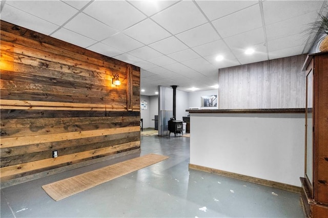 11155 Hubbard Rd, Kansas City, KS 66109 - reception featuring a wood stove, a drop ceiling, wood walls, and recessed lighting
