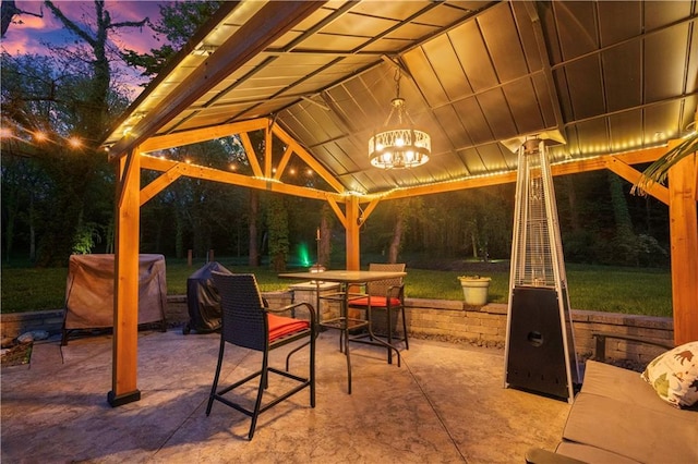 11155 Hubbard Rd, Kansas City, KS 66109 - patio terrace at dusk with a gazebo, a patio, outdoor dining space, and a yard
