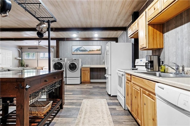 11155 Hubbard Rd, Kansas City, KS 66109 - kitchen with white appliances, washer and clothes dryer, a sink, dark wood finished floors, and light countertops