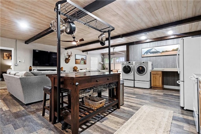11155 Hubbard Rd, Kansas City, KS 66109 - kitchen with washer and clothes dryer, open floor plan, wooden ceiling with exposed beams, wood finished floors, and light countertops
