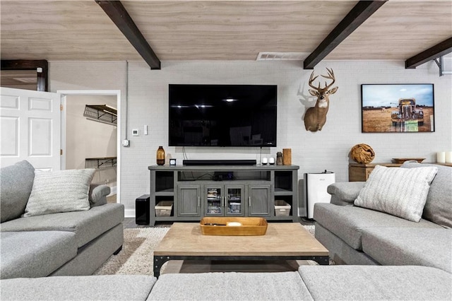 11155 Hubbard Rd, Kansas City, KS 66109 - living room featuring wooden ceiling with exposed beams and brick wall