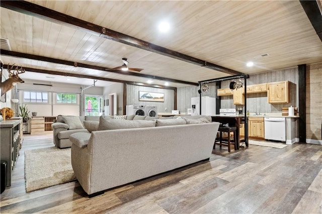 11155 Hubbard Rd, Kansas City, KS 66109 - living area with separate washer and dryer, wood finished floors, wood ceiling with exposed beams, and ceiling fan