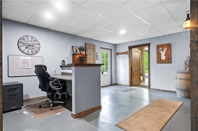 11155 Hubbard Rd, Kansas City, KS 66109 - home office with baseboards, finished concrete flooring, a drop ceiling, and recessed lighting