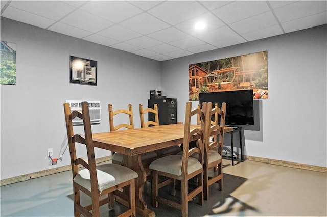 11155 Hubbard Rd, Kansas City, KS 66109 - dining room featuring a drop ceiling, baseboards, and finished concrete floors