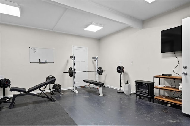 11155 Hubbard Rd, Kansas City, KS 66109 - workout area with a wood stove and baseboards