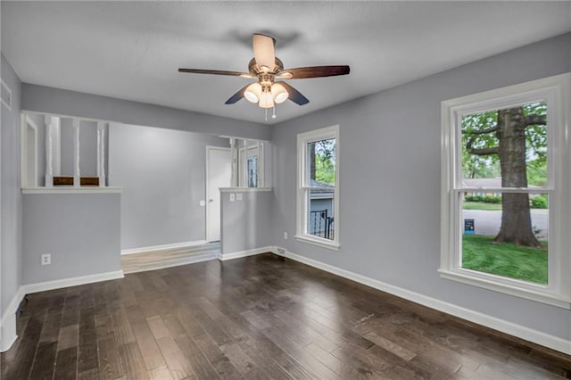 spare room with baseboards, a ceiling fan, and wood finished floors