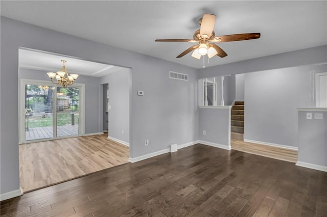 unfurnished living room featuring baseboards, visible vents, and wood finished floors