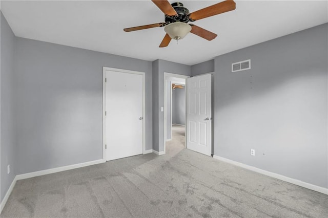 unfurnished bedroom featuring visible vents, carpet, and baseboards