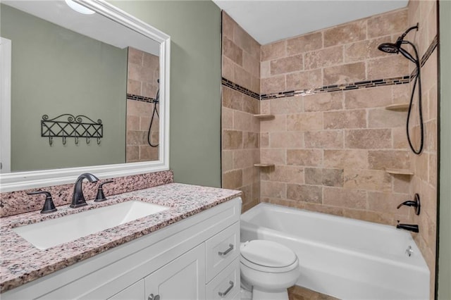 bathroom featuring vanity, shower / bathing tub combination, and toilet