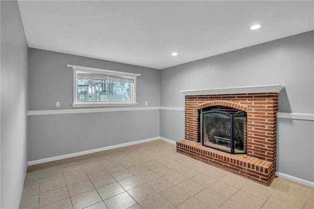 unfurnished living room featuring recessed lighting, baseboards, tile patterned floors, and a fireplace