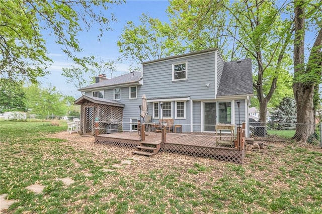 back of house with a fenced backyard, a shingled roof, a yard, and a deck