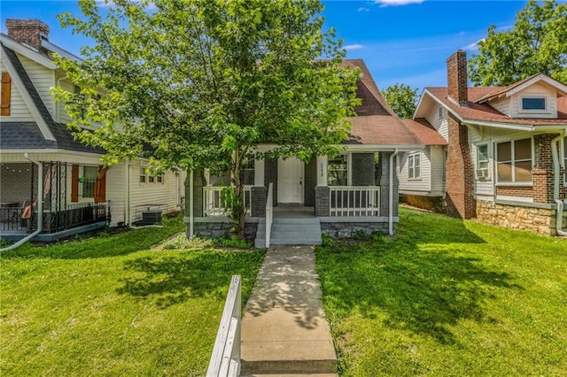 2219 E Meyer Blvd, Kansas City, MO 64132 - view of front of property with covered porch and a front yard