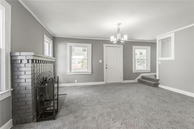 2219 E Meyer Blvd, Kansas City, MO 64132 - carpeted living area with ornamental molding, a chandelier, a fireplace, and baseboards