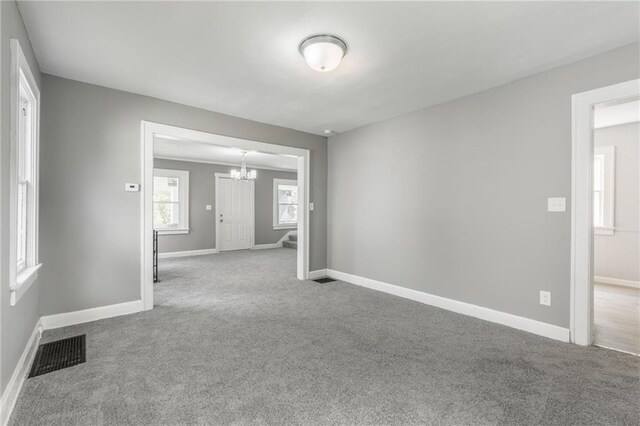 2219 E Meyer Blvd, Kansas City, MO 64132 - empty room with a chandelier, carpet floors, and baseboards
