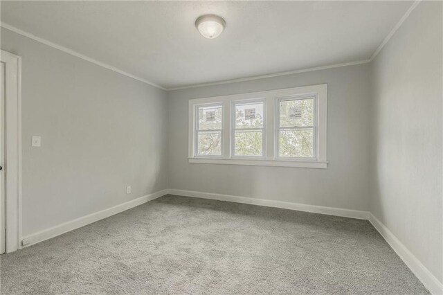 2219 E Meyer Blvd, Kansas City, MO 64132 - carpeted empty room with crown molding and baseboards