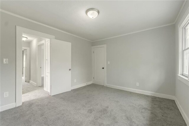 2219 E Meyer Blvd, Kansas City, MO 64132 - unfurnished room featuring carpet, plenty of natural light, baseboards, and ornamental molding