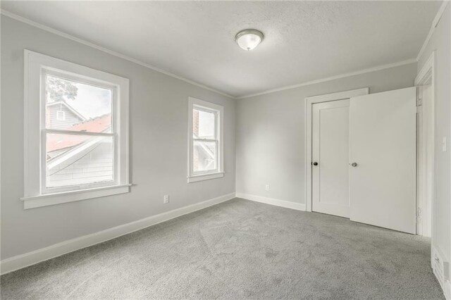 2219 E Meyer Blvd, Kansas City, MO 64132 - unfurnished bedroom featuring ornamental molding, carpet flooring, and baseboards