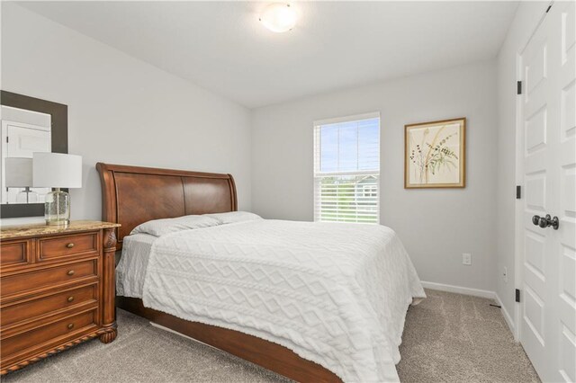 carpeted bedroom with baseboards