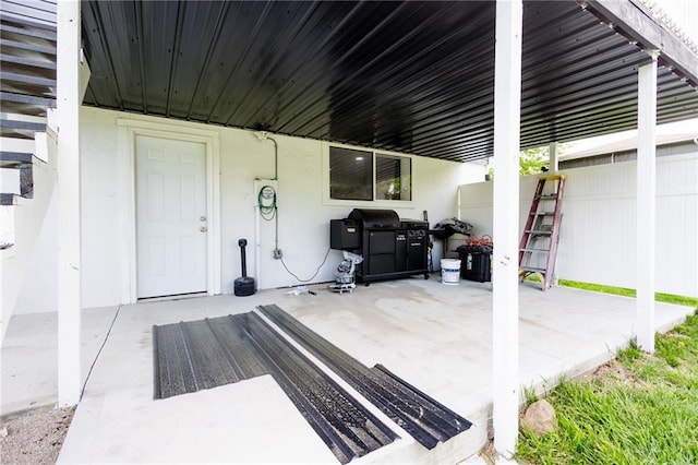 view of patio / terrace featuring fence and a grill