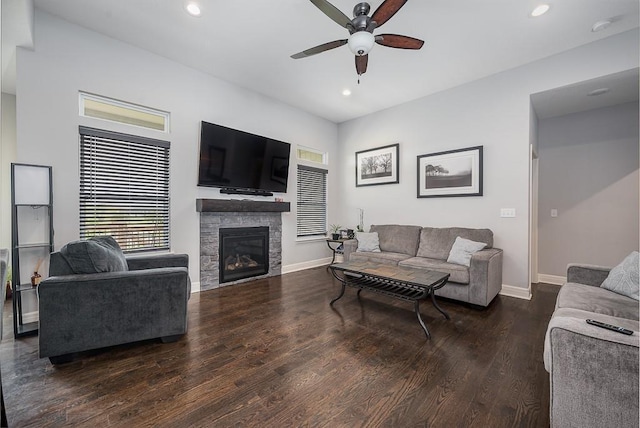 living area featuring recessed lighting, wood finished floors, a ceiling fan, baseboards, and a fireplace