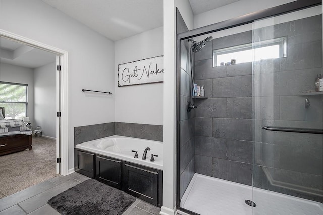 bathroom featuring a bath, a shower stall, and a wealth of natural light