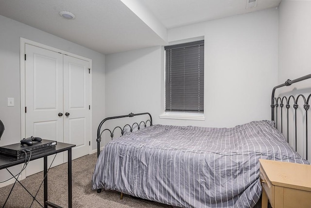 bedroom featuring carpet floors, a closet, baseboards, and visible vents