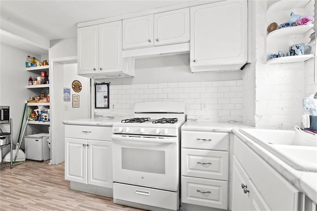 510 E Park St, Olathe, KS 66061 - kitchen with white range with gas cooktop, open shelves, and white cabinets