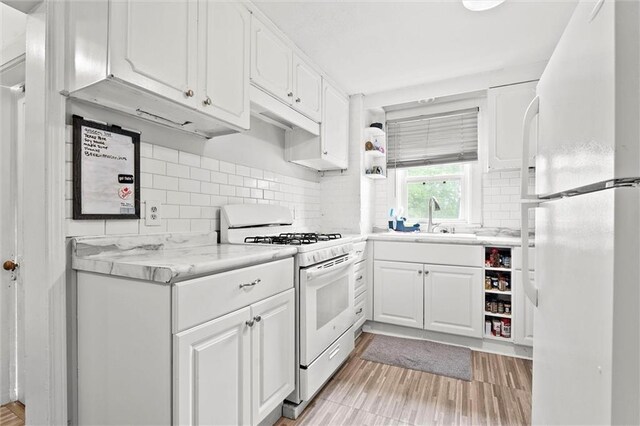 510 E Park St, Olathe, KS 66061 - kitchen featuring white appliances, white cabinets, light countertops, and backsplash