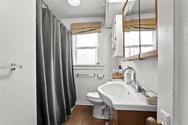 510 E Park St, Olathe, KS 66061 - bathroom featuring vanity, wood finished floors, a shower with shower curtain, and a textured ceiling