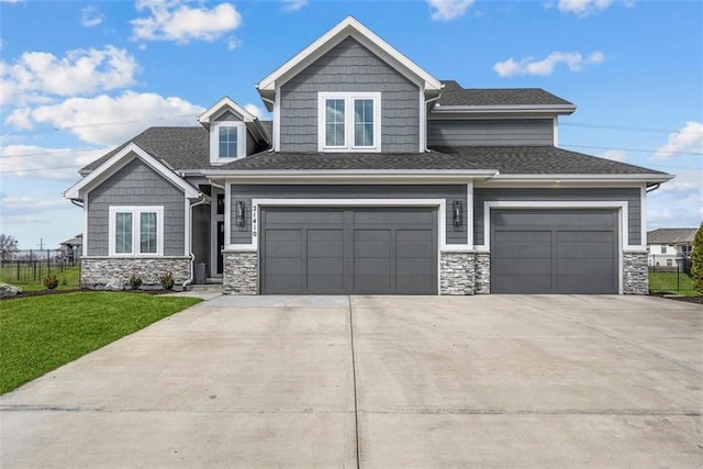 21410 W 189th Ter, Spring Hill, KS 66083 - view of front of property featuring stone siding, driveway, an attached garage, and a shingled roof