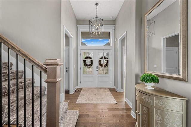 21410 W 189th Ter, Spring Hill, KS 66083 - entrance foyer with a chandelier, wood finished floors, stairs, and baseboards
