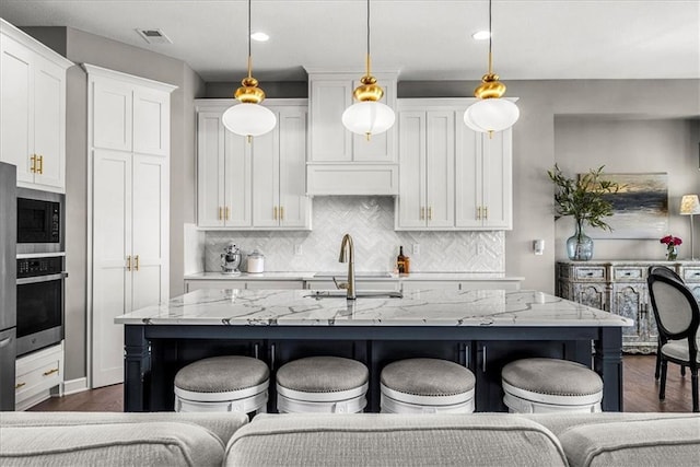 21410 W 189th Ter, Spring Hill, KS 66083 - kitchen featuring stainless steel oven, dark wood finished floors, white cabinetry, a breakfast bar area, and recessed lighting
