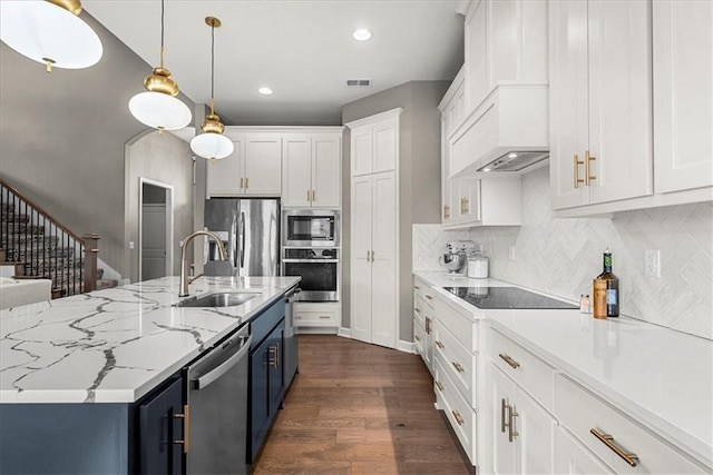 21410 W 189th Ter, Spring Hill, KS 66083 - kitchen featuring stainless steel appliances, blue cabinets, a sink, white cabinets, and recessed lighting